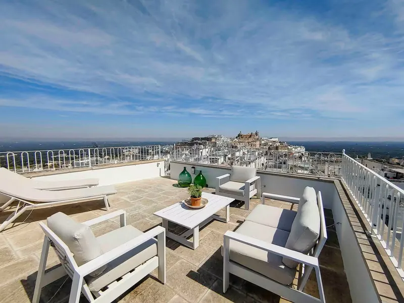 Casa Chiara rooftop terrace with sofas and views over Ostuni